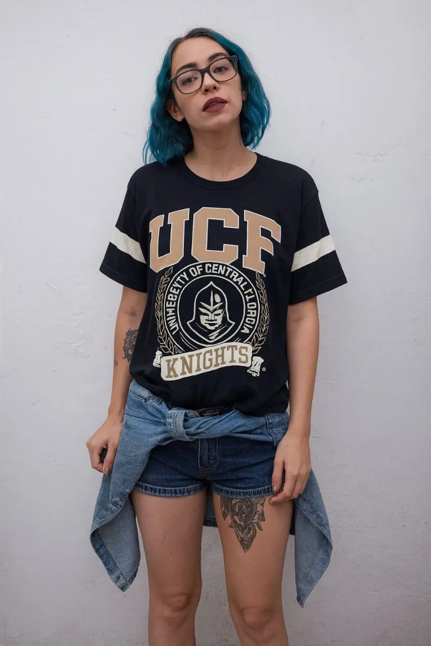 Womens-Black-UCF-Knights-Graphic-T-Shirt-–-Retro-Collegiate-Style.webp Women’s Black UCF Knights Graphic T-Shirt – Retro Collegiate Style - Image 1